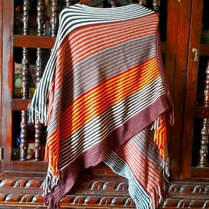 Knit poncho with fringed edges